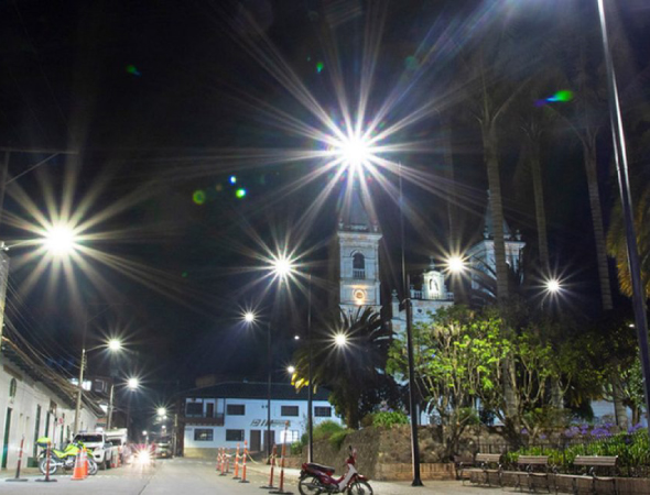 Photo of Colombian city lit up, nighttime setting.